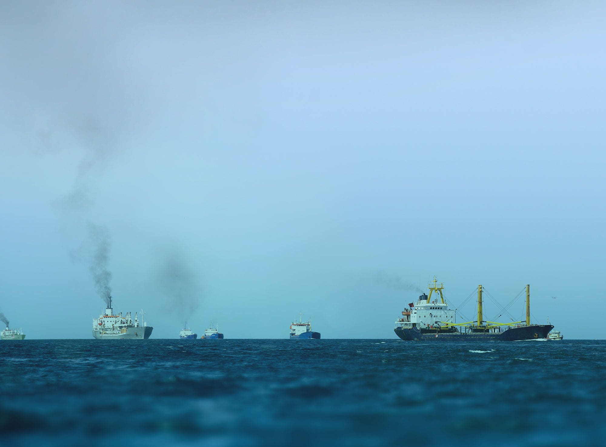 A group of large tanker ships on the ocean